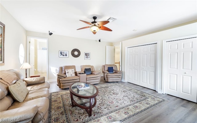 living room with ceiling fan and wood-type flooring