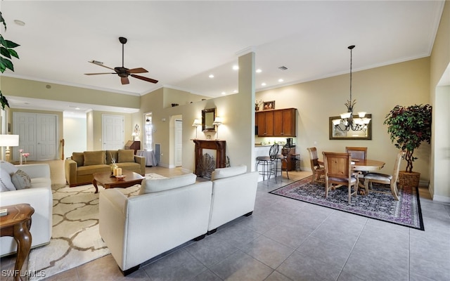 living room with ceiling fan with notable chandelier, tile patterned floors, and crown molding