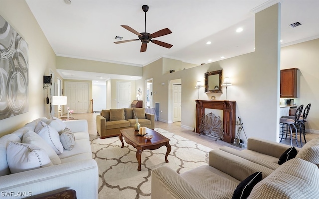 living room featuring ceiling fan and ornamental molding