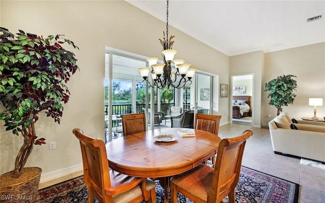 tiled dining area featuring a chandelier