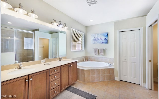 full bathroom featuring tile patterned floors, vanity, toilet, and independent shower and bath