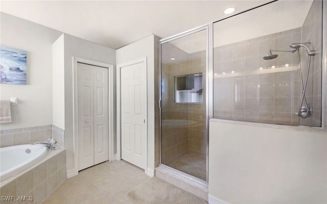 bathroom with tile patterned floors and separate shower and tub