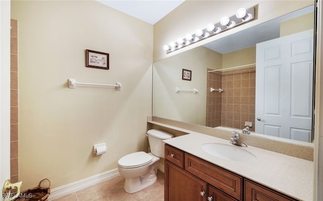 bathroom with toilet, vanity, and tile patterned floors