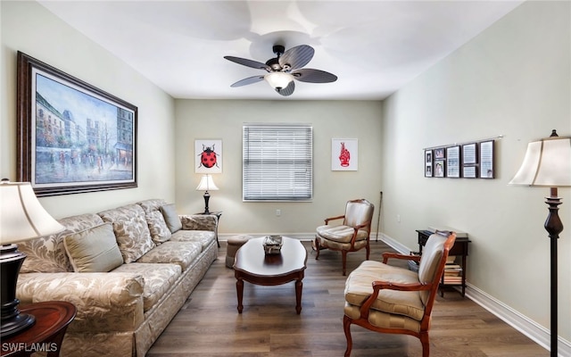 living room with ceiling fan and dark wood-type flooring