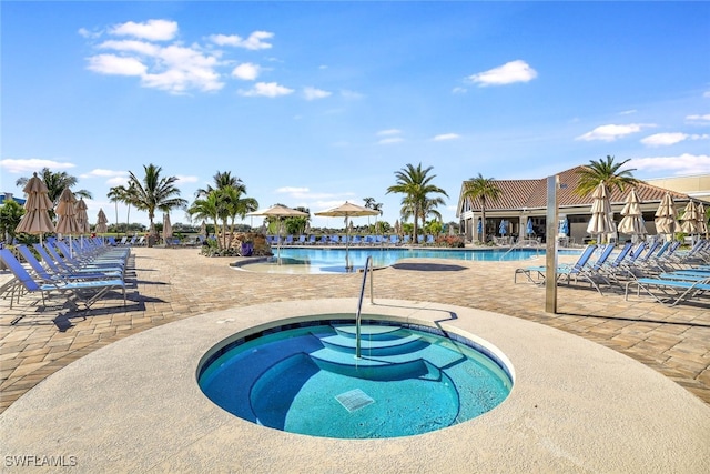 view of pool featuring a patio area and a hot tub