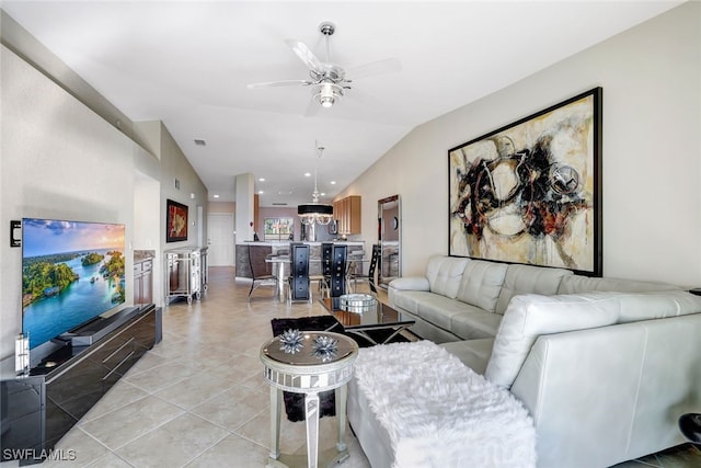 living room with light tile patterned floors, vaulted ceiling, and ceiling fan