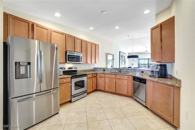 kitchen with light stone countertops, appliances with stainless steel finishes, ceiling fan, sink, and light tile patterned floors