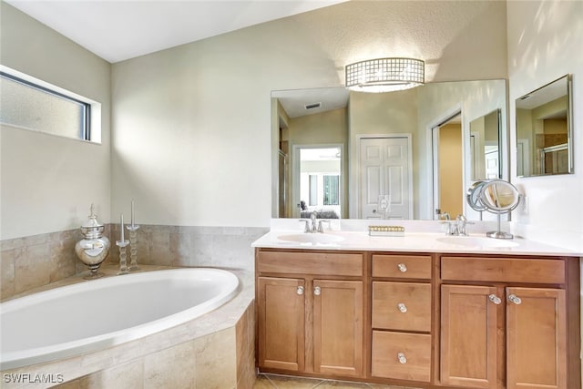 bathroom featuring tile patterned flooring, vanity, separate shower and tub, and lofted ceiling