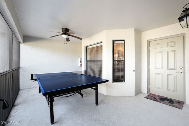 playroom with light colored carpet and ceiling fan