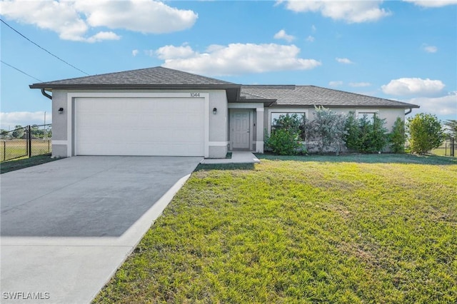 view of front of house with a garage and a front lawn