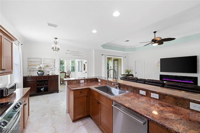 kitchen featuring a sink, crown molding, dark stone counters, and stainless steel appliances