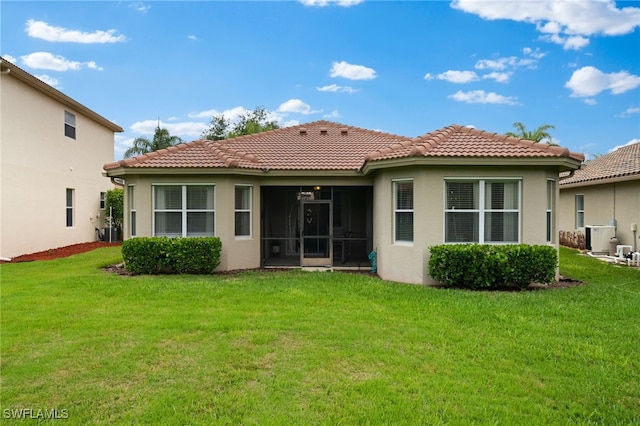 rear view of property featuring a tiled roof, a yard, central air condition unit, and a sunroom