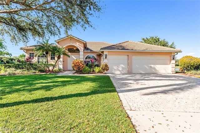 mediterranean / spanish-style house featuring a garage and a front yard