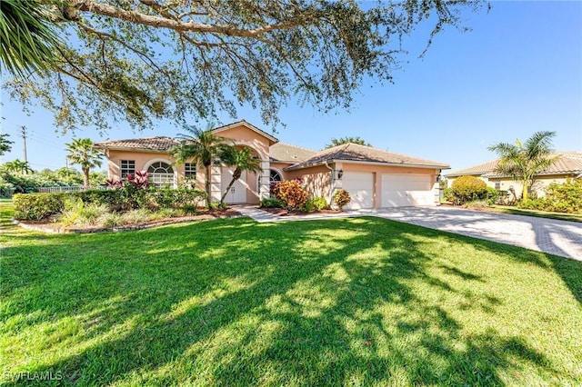 mediterranean / spanish-style house with a front yard and a garage