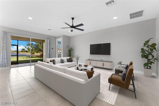 living area with light tile patterned floors, visible vents, recessed lighting, and a ceiling fan