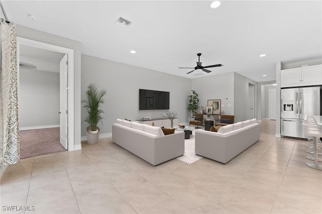 living area with a ceiling fan, visible vents, baseboards, light tile patterned flooring, and recessed lighting