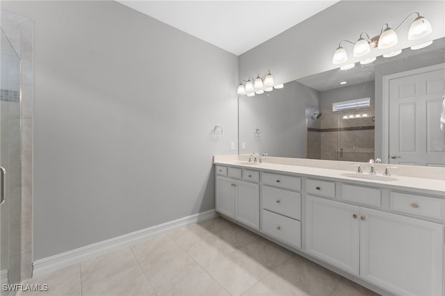 bathroom with walk in shower, vanity, and tile patterned flooring