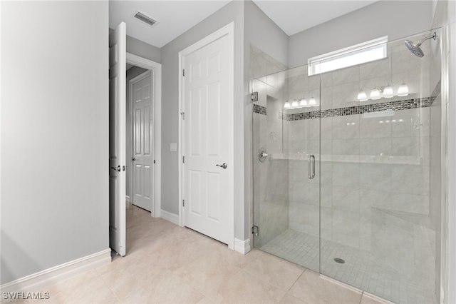 full bath featuring tile patterned flooring, visible vents, a shower stall, and baseboards