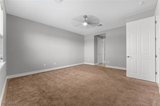 unfurnished room with ceiling fan and carpet flooring