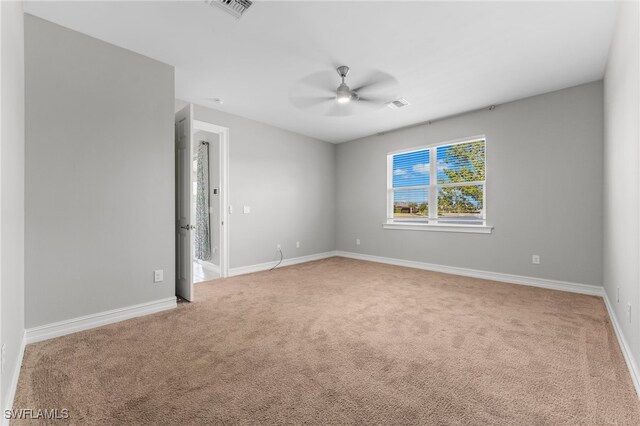 carpeted empty room featuring ceiling fan