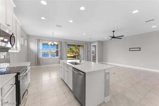 kitchen with visible vents, appliances with stainless steel finishes, light countertops, and a sink