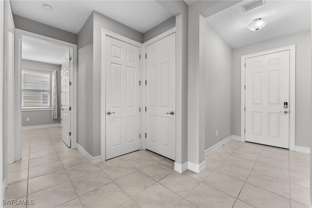 foyer entrance with light tile patterned flooring