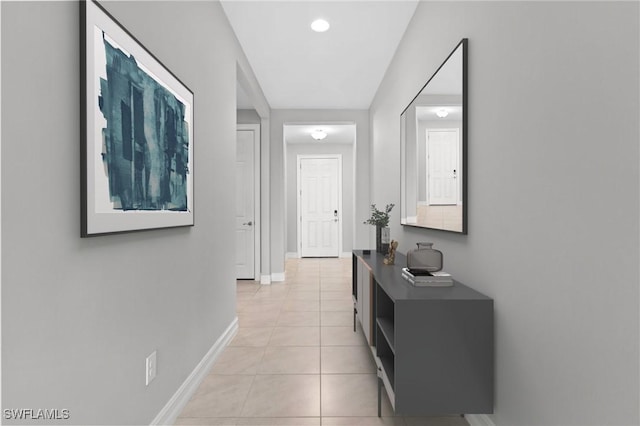 hall featuring light tile patterned floors