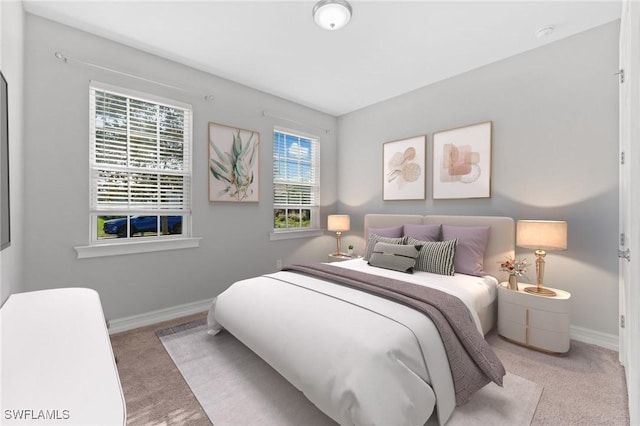 carpeted bedroom featuring baseboards