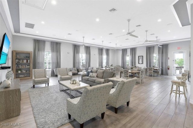 living room featuring crown molding, recessed lighting, visible vents, and wood tiled floor