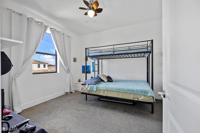 bedroom featuring carpet flooring, ceiling fan, and a textured ceiling