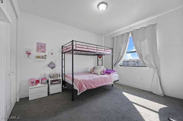 bedroom featuring a closet and dark carpet