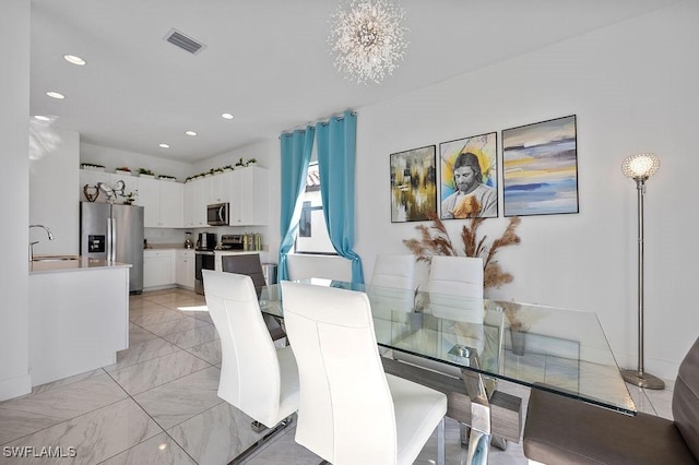 dining room featuring a notable chandelier and sink