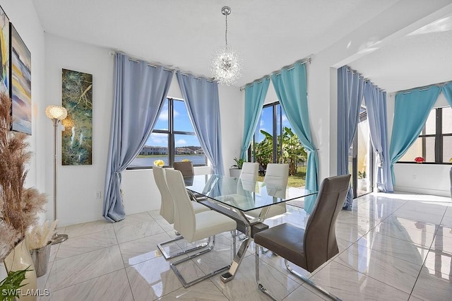 dining area with an inviting chandelier