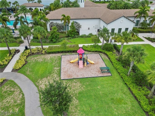 view of home's community featuring a yard and a playground