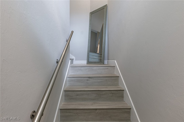 stairway featuring hardwood / wood-style flooring