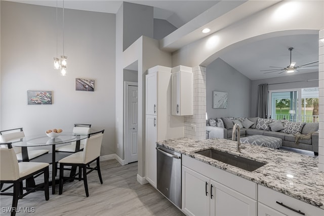 kitchen with dishwasher, white cabinets, sink, light hardwood / wood-style flooring, and ceiling fan