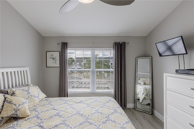 bedroom featuring ceiling fan, vaulted ceiling, and light wood-type flooring