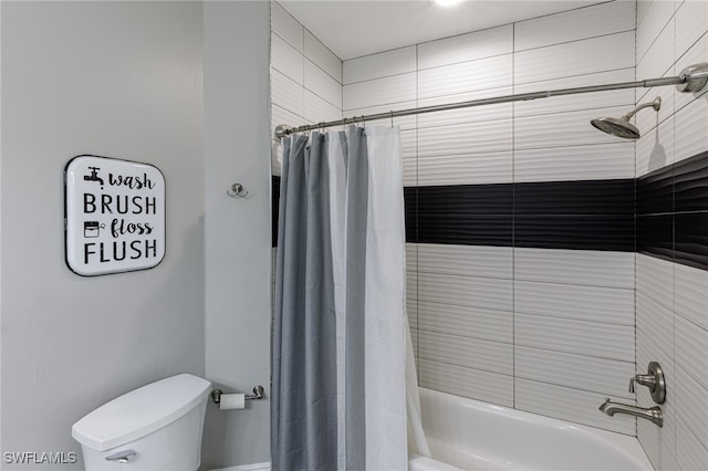 bathroom featuring shower / bath combination with curtain and toilet