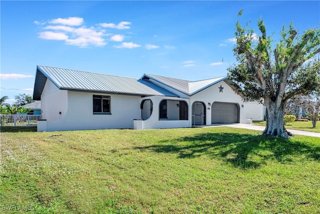 ranch-style home featuring a garage and a front lawn