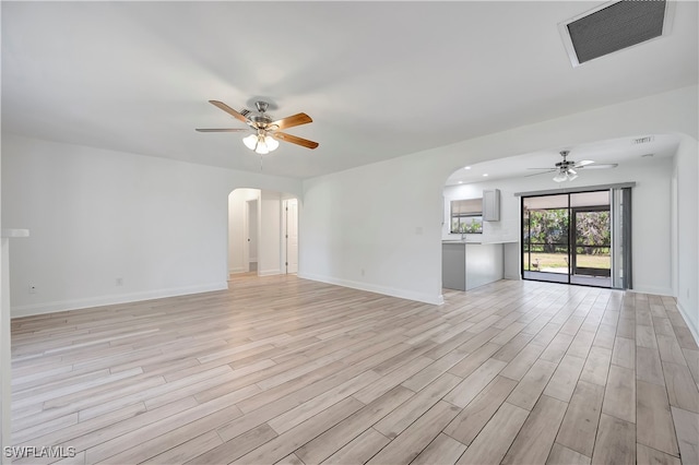 unfurnished living room featuring light wood-type flooring and ceiling fan