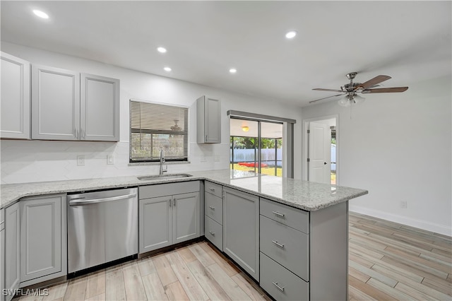 kitchen with gray cabinets, dishwasher, light hardwood / wood-style floors, and sink