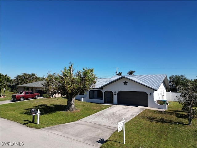 view of front of property featuring a garage and a front yard