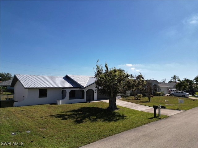 ranch-style home featuring a front yard