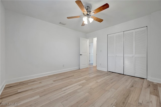 unfurnished bedroom with ceiling fan, a closet, and light hardwood / wood-style floors