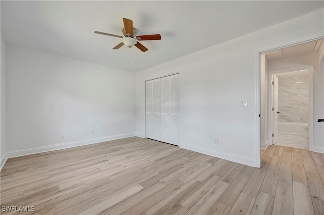 unfurnished bedroom featuring a closet, light hardwood / wood-style flooring, and ceiling fan