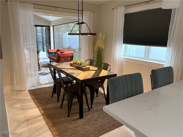 dining area with light tile patterned flooring and a healthy amount of sunlight