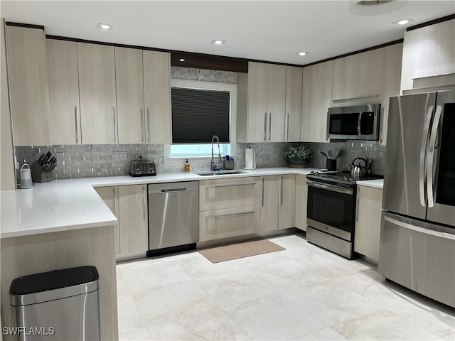 kitchen with sink, stainless steel appliances, and tasteful backsplash