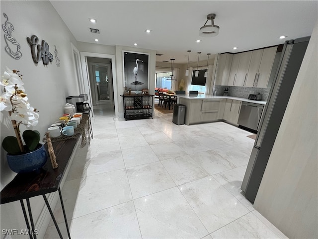 kitchen with gray cabinetry, dishwasher, decorative backsplash, decorative light fixtures, and a breakfast bar area