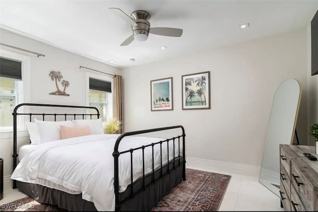 tiled bedroom featuring ceiling fan