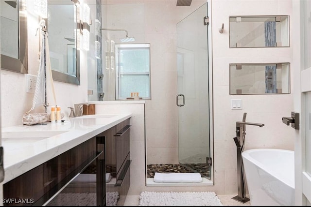 bathroom with vanity and separate shower and tub